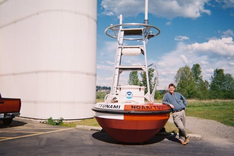 Dr Rob Bell beside a DART® tsunami buoy.