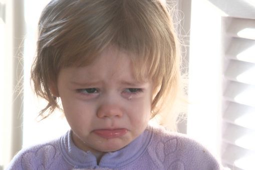 Close up face of a young child crying.