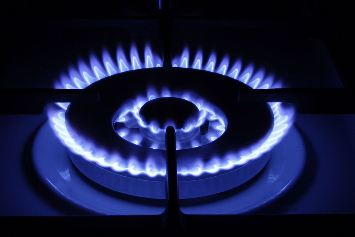 Oven Gas burner with purple/blue flames.