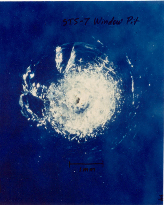Window pit from space junk that hit the Space Shuttle Challenger