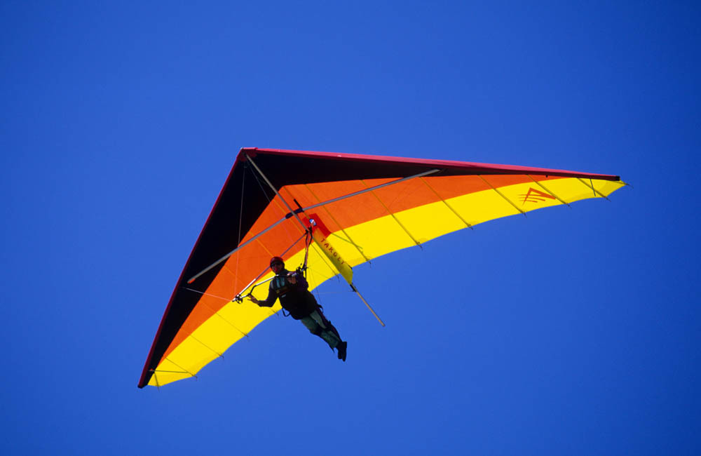 Looking up at a person in their hang-glider.