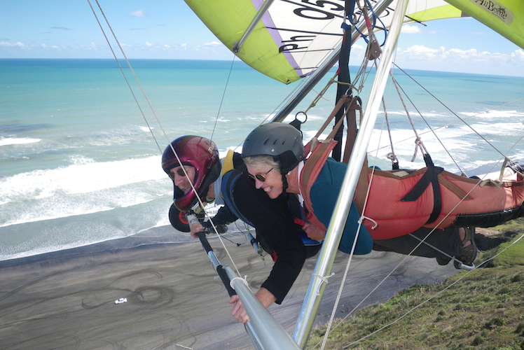 Flying in tandem on a hang-glider over a New Zealand coast 