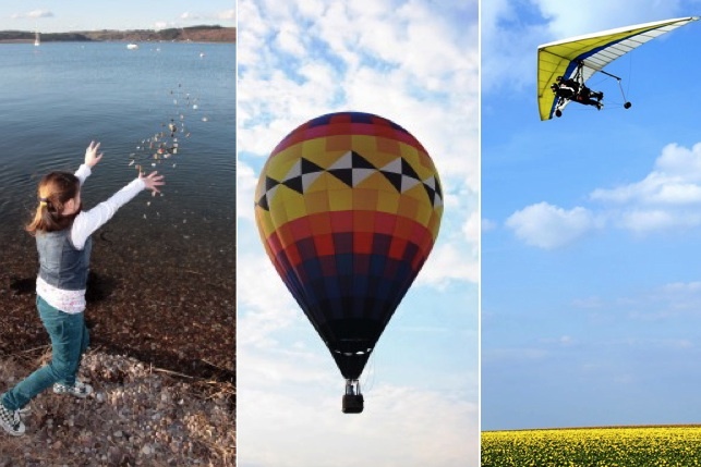 Girl throwing stones by lake, hot-air balloon, and a hang-glider