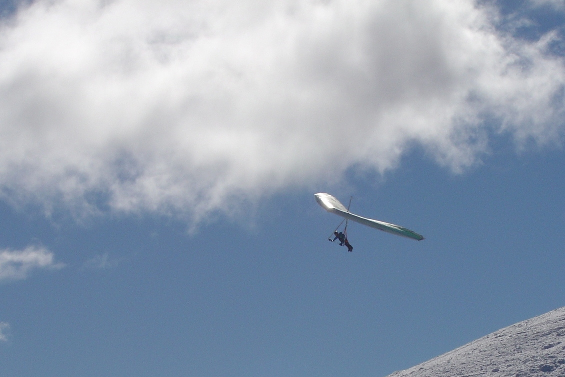 Looking up a blue sky and a Hang-gliding.