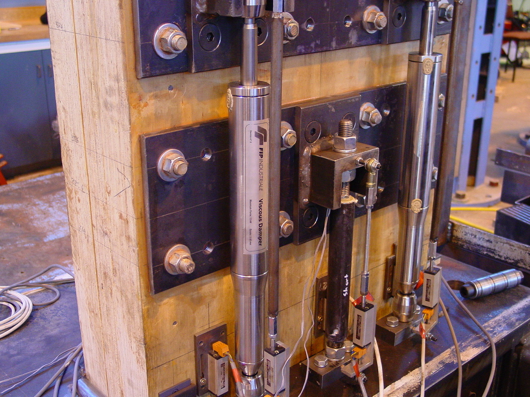 Example of experimental dampers on a wooden building column.