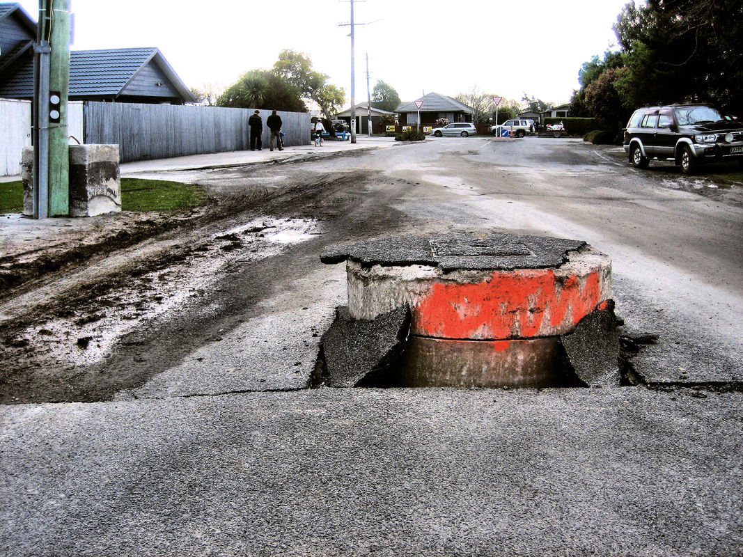 Earthquake pushed storm drain up through road Christchurch, 2010