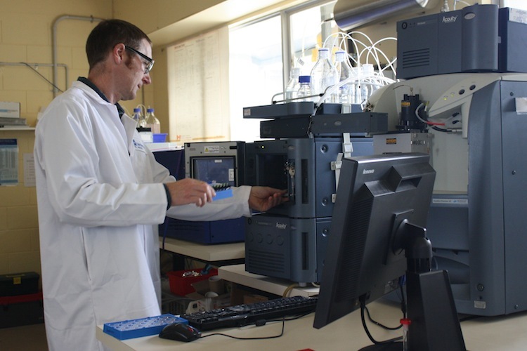 Scientist and a liquid chromatography-mass spectrometry machine