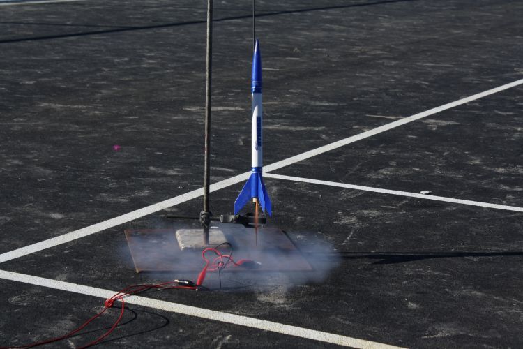 A model rocket at the moment of launch outside.