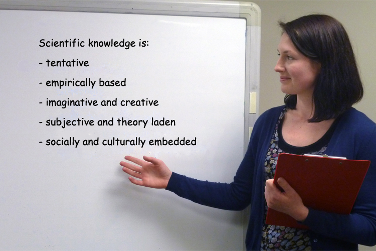 Teacher by white board with a list of what science knowledge is