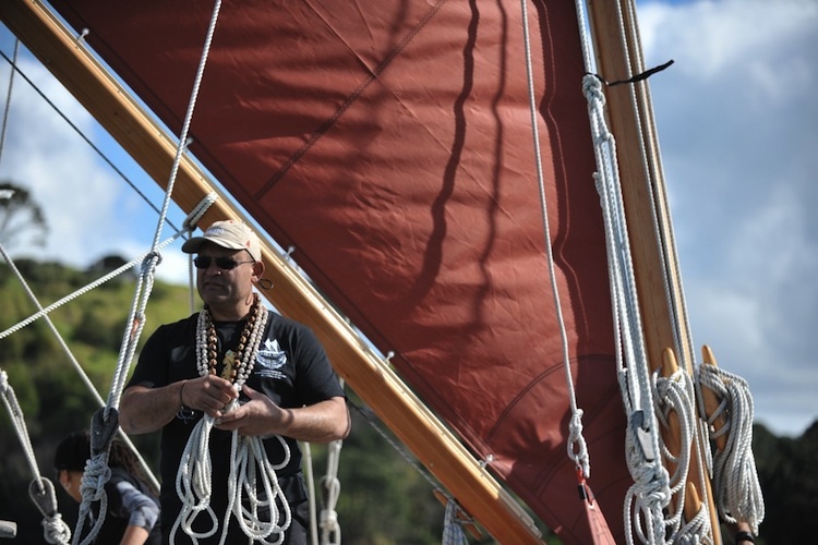 Navigator Jack Thatcher on waka standing by sail. 