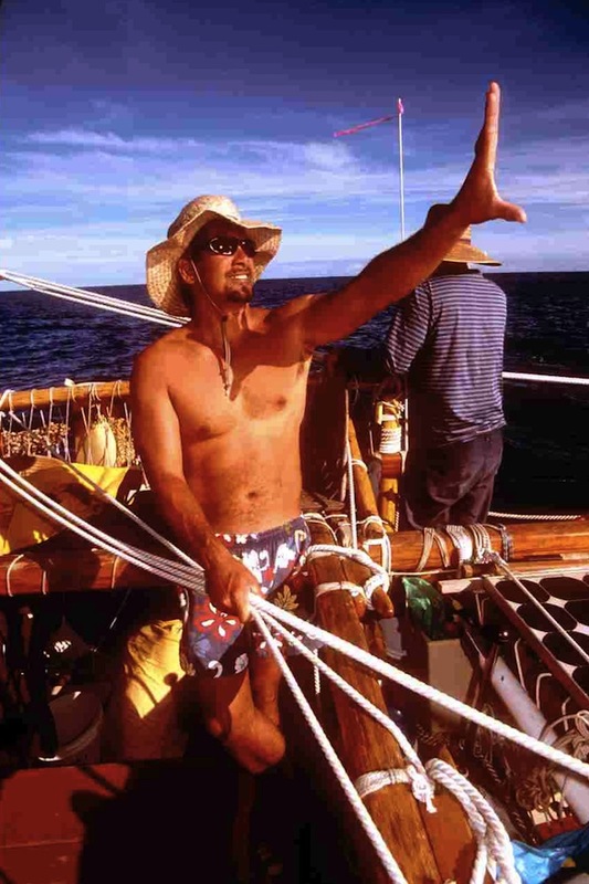Navigator using his hand to measure altitude of the Sun on boat