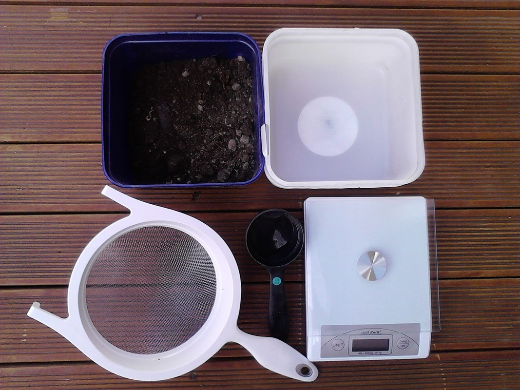 Investigating soil moisture equipment: sieve, scale, boxes, soil