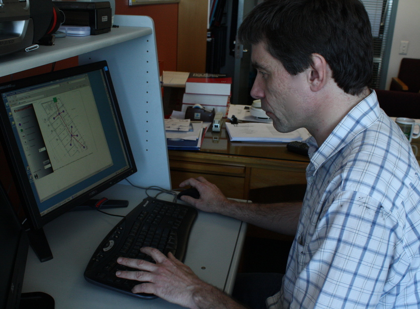 Dr Mike Spearpoint works on a fire evacuation model on computer