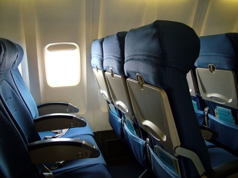Empty blue aircraft seats.