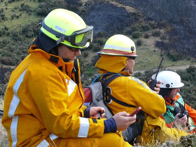 Scientists monitoring fire experiments outside.