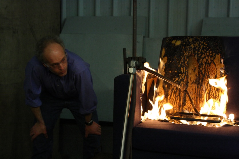 Scientist Charley Fleischmann observing a burning sofa