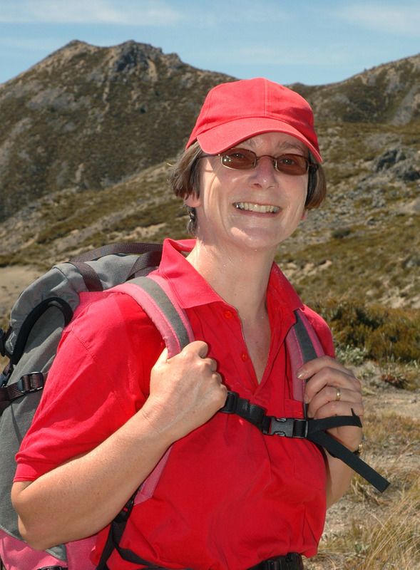 Scientist Lisa Langer wearing red hiking outside.