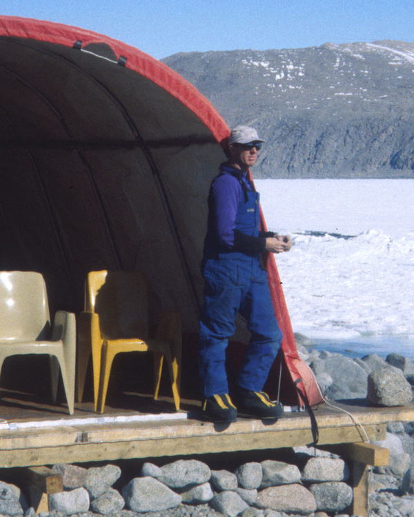 Scientist on location in Antarctica at entrance to tent.