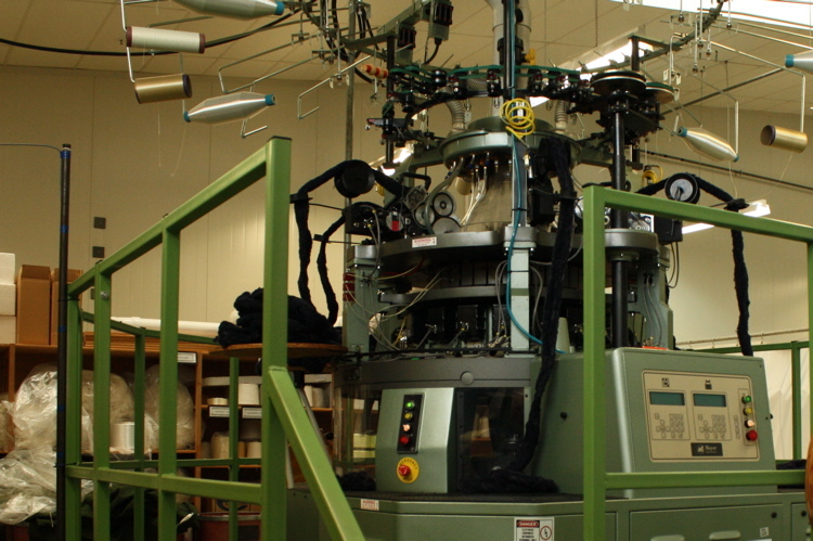 Fibreknit machine for making stab and flame-resistant fabric