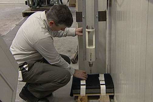 Scientist testing measure stab resistance.