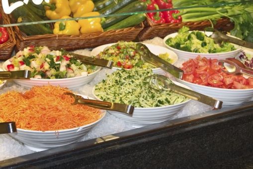 Selection of different salads at a salad buffet bar.