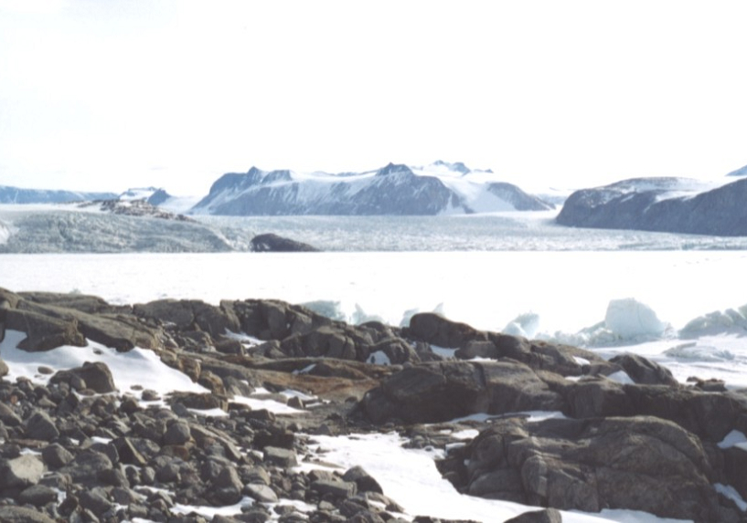 Antarctic landscape, rocks, ice, snow, mountains.