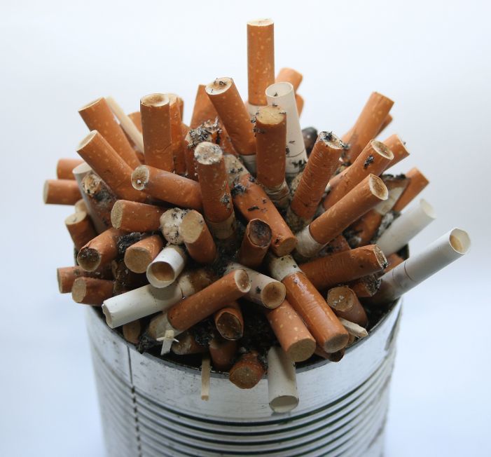 Tin can of cigarette butts.
