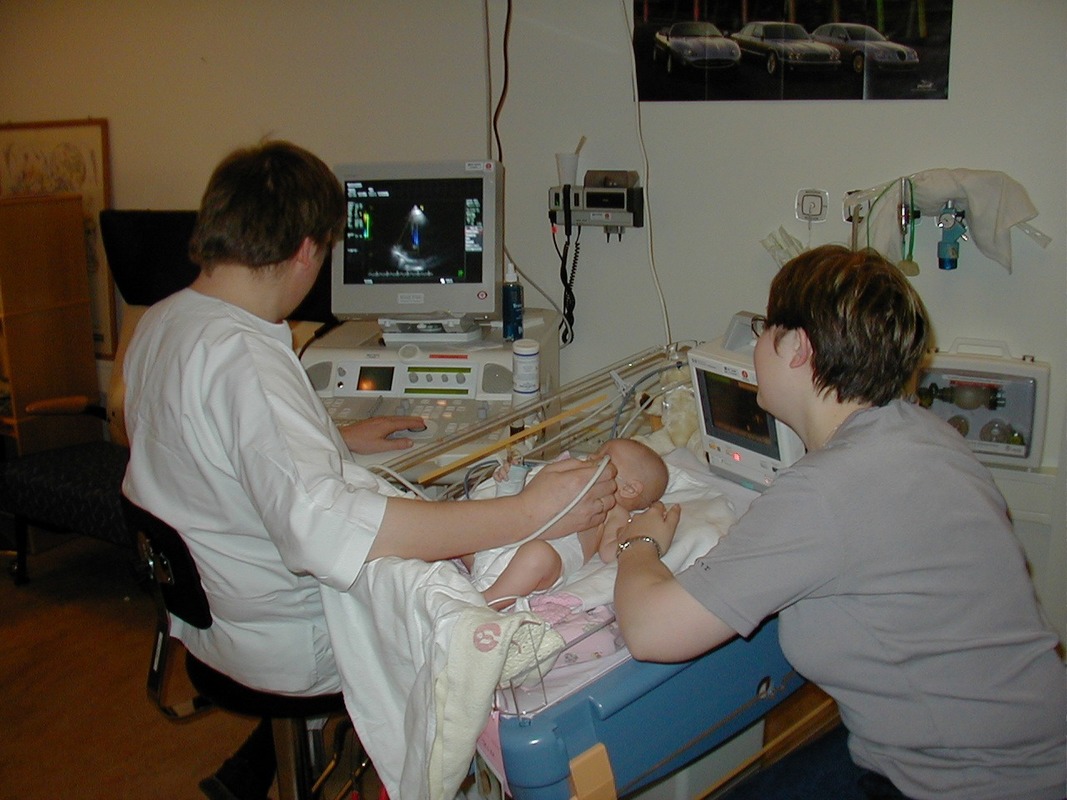Sonographer performing ultrasound examination of a baby's heart.
