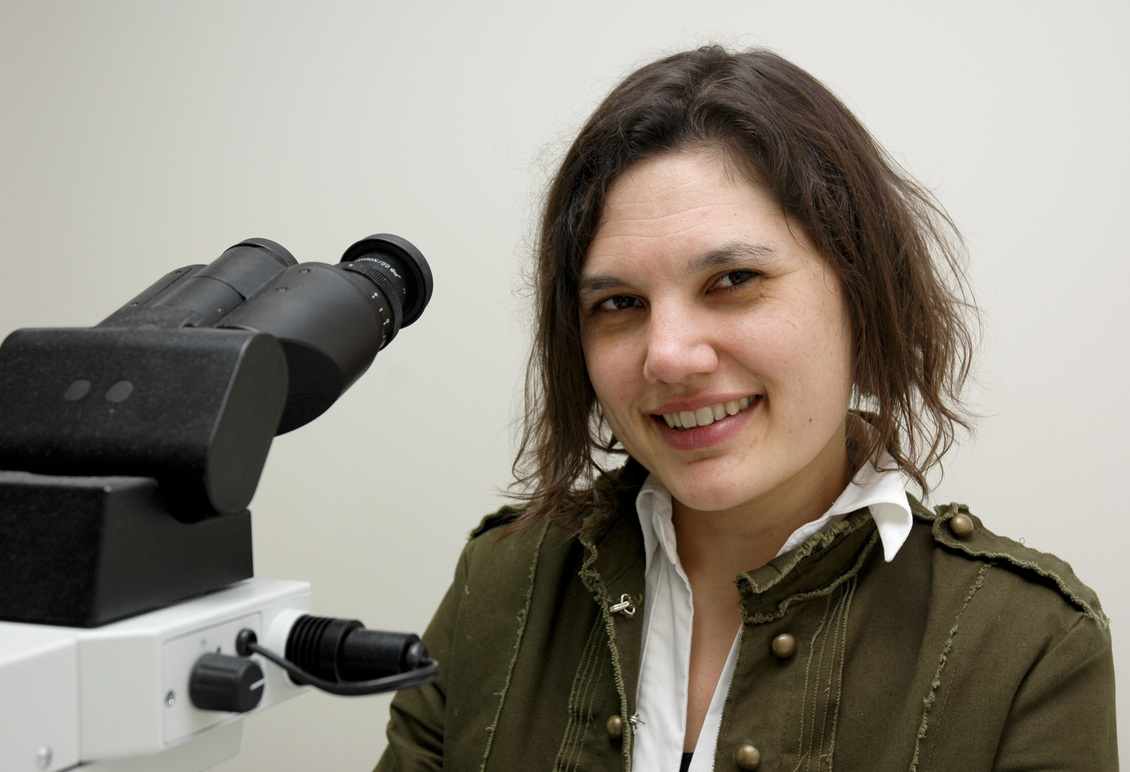 Pathologist Dr Catherine Koleda by mircroscope.