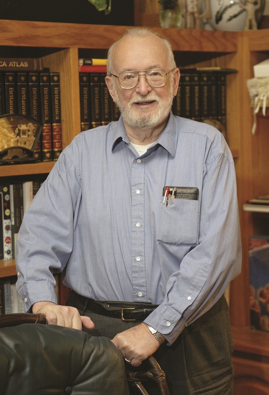 Dr Paul Lauterbur (1929–2007) with bookcase behind him.