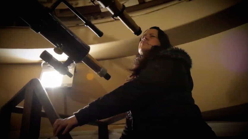 Astrophysicist Dr Pauline Harris looking through a telescope, NZ