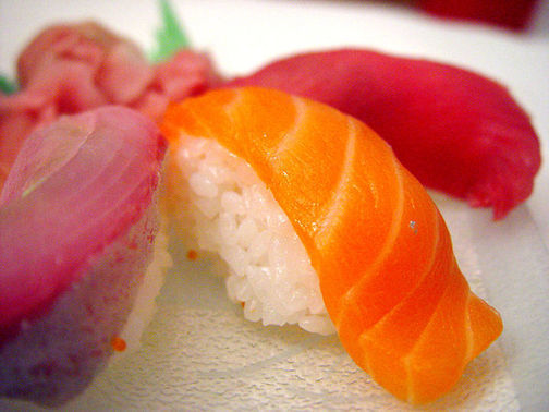 Close up of sushi with fish on top.