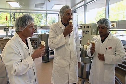 3 scientists taste enriched ice cream in the lab.