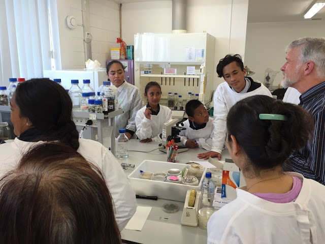 School students with Dr Peter Buchanan in a lab