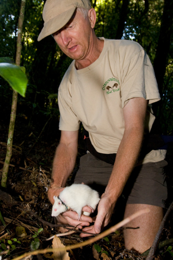 Scientist John Innes and a white rat in bush