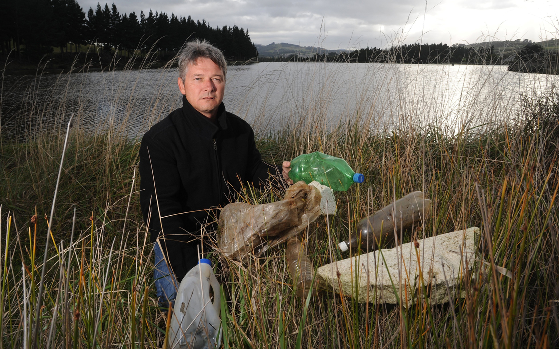 Keith McFadyen displays rubbish found in the Kaikorai Estuary.