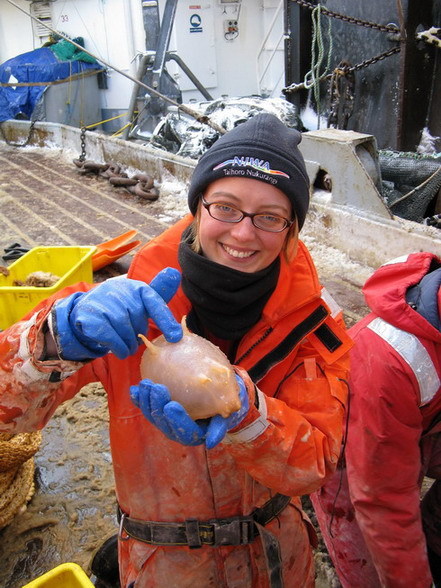 Sadie Mills holding a sea cucumber (Scotoplanes globosa) on ship