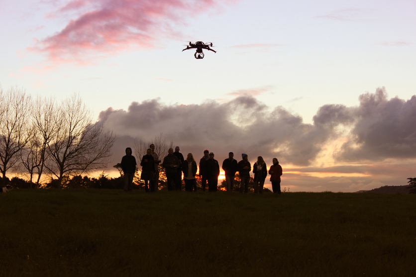 Sunrise/Sunset Aeronavics team and a flying drone outisde