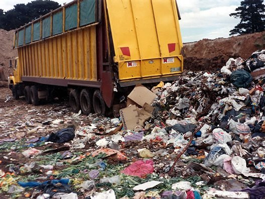 A truck dumping waste at a resource depot/landfill dump.