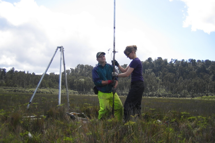 2 scientists coring by hand at Ōkārito, New Zealand