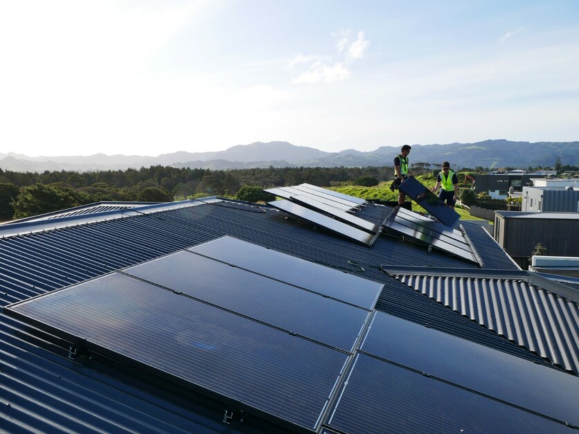 Solar panels being fixed to a roof in New Zealand