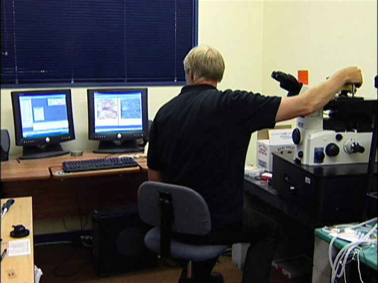 Scientist in lab with an atomic force microscope