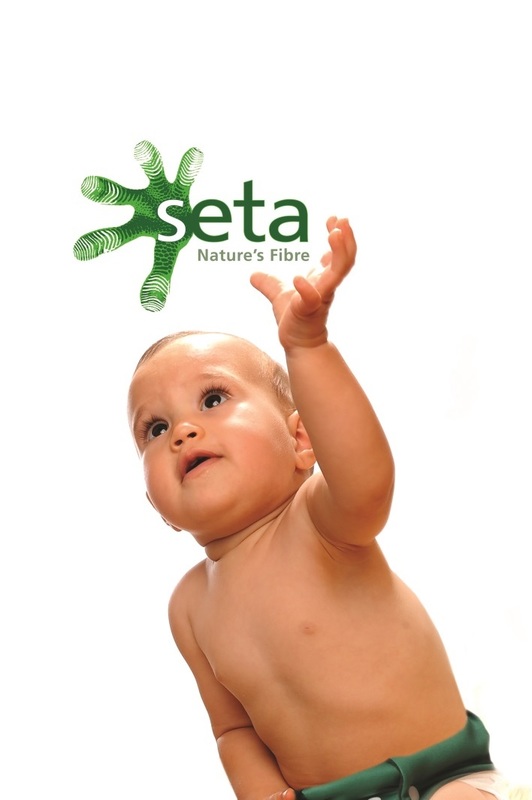 Baby "holding" SetaTM air filters logo