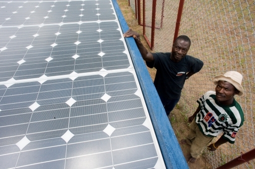 Solar power generation facility with two workers in Africa.