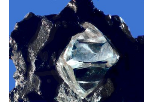 Nearly octahedral diamond crystal in matrix.