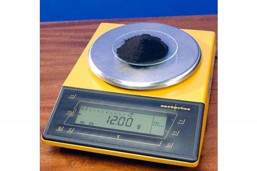 Scales with 12 grams of pure carbon-12 powder.