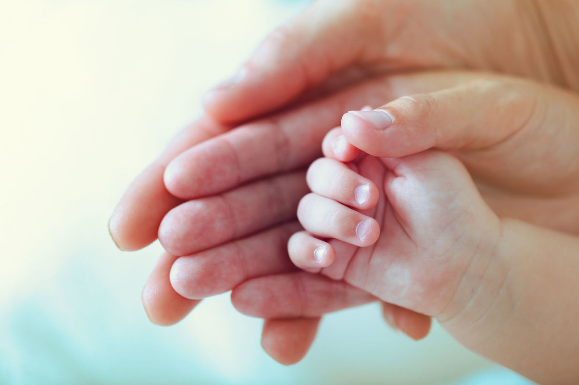 Adults and infant's hands.