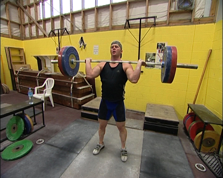 Athlete showing Stage 1 of the Olympic lift in weightlifting
