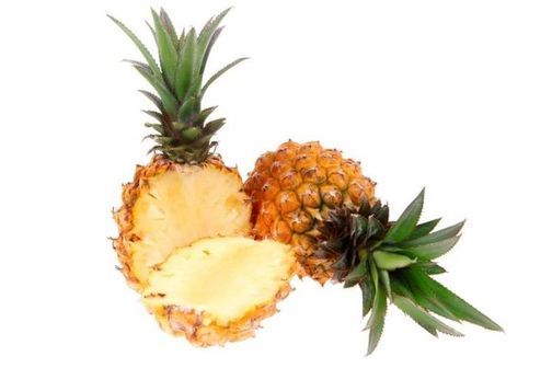 Two pineapples, one slided in half on white background.