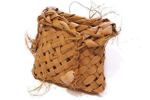 A kete is a bag or basket made of flax on white background